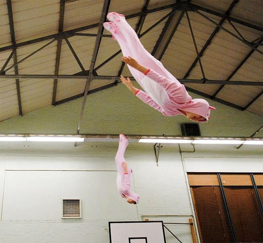 Two gymnasts bouncing in a fancy dress costumes