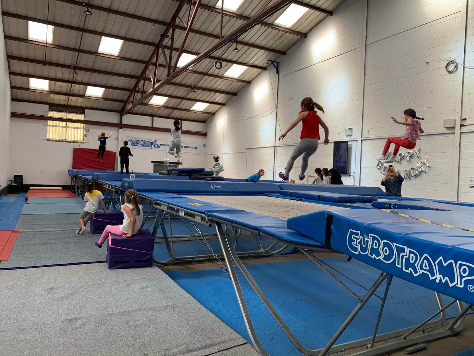 The main trampoline hall with gymnasts jumping on the trampolines